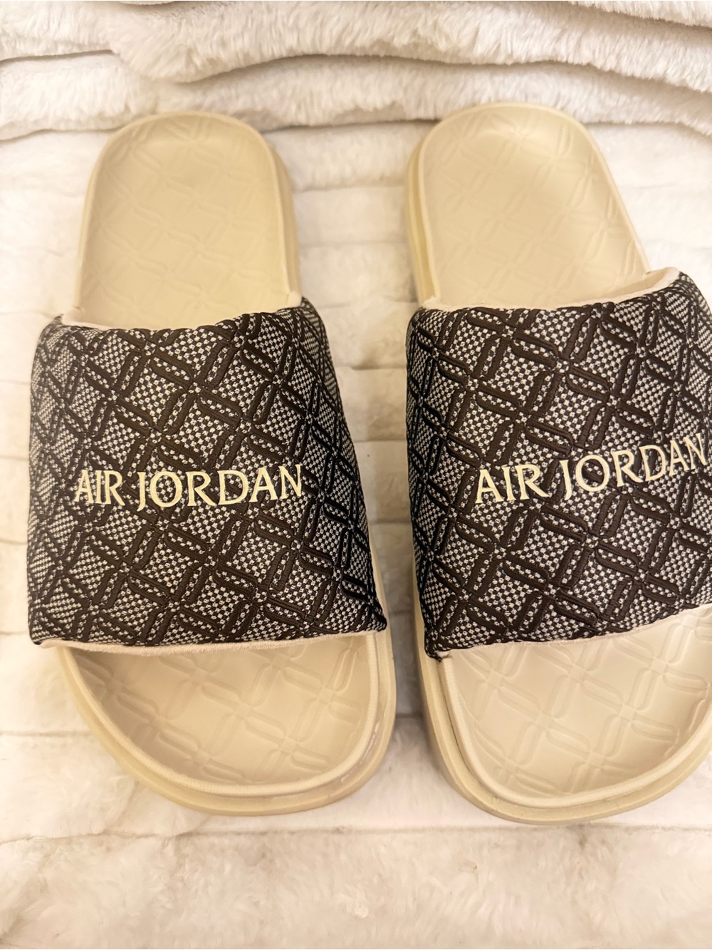 Jordan beige and black slide sandals with Jumpman logo